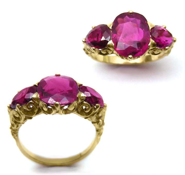 Three stone Burma ruby ring, the central oval cushion-cut ruby,